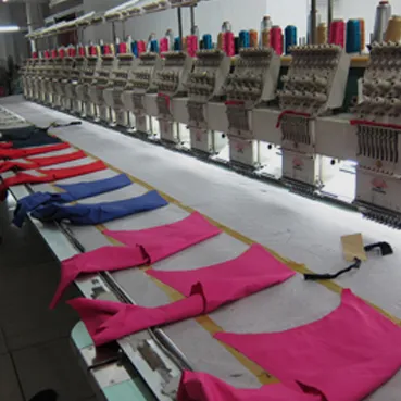 Multi-head embroidery machine with cut garment panels
